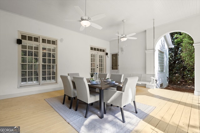 dining room with hardwood / wood-style flooring, french doors, and a ceiling fan