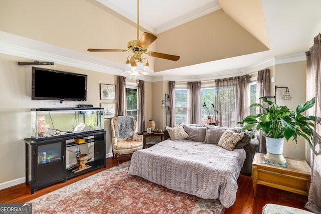 bedroom with wood finished floors, crown molding, lofted ceiling, baseboards, and ceiling fan