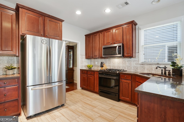 655 Grove Manor Ct, Suwanee, GA 30024 - kitchen with stainless steel appliances, backsplash, recessed lighting, and dark stone countertops