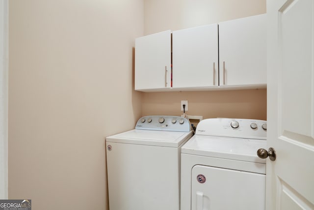 655 Grove Manor Ct, Suwanee, GA 30024 - laundry room with cabinet space and washing machine and dryer