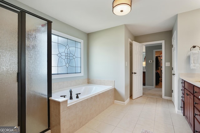 655 Grove Manor Ct, Suwanee, GA 30024 - bathroom featuring vanity, a bath, a shower stall, a spacious closet, and tile patterned floors