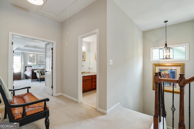 655 Grove Manor Ct, Suwanee, GA 30024 - hallway with light carpet, attic access, and an upstairs landing