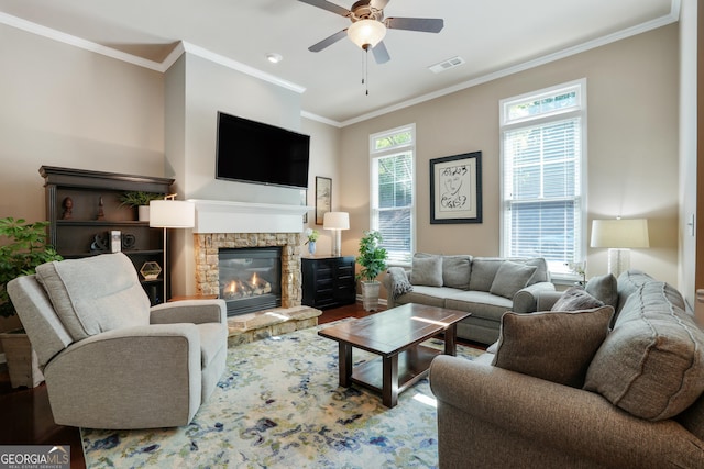 655 Grove Manor Ct, Suwanee, GA 30024 - living area with a stone fireplace, crown molding, ceiling fan, and wood finished floors