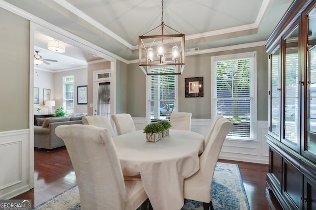 655 Grove Manor Ct, Suwanee, GA 30024 - dining room with wainscoting, crown molding, dark wood-style floors, a ceiling fan, and a decorative wall