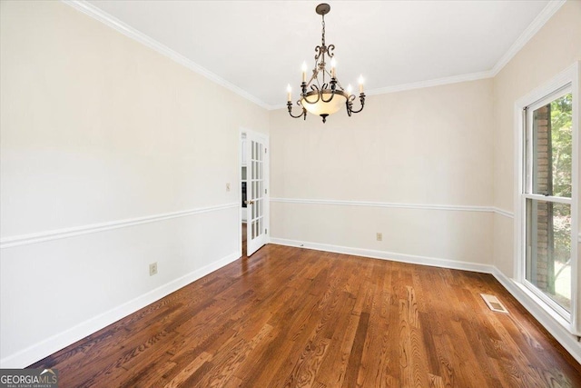 unfurnished dining area featuring a chandelier, wood finished floors, baseboards, and ornamental molding