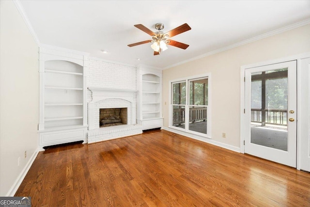 unfurnished living room featuring built in shelves, crown molding, a ceiling fan, wood finished floors, and baseboards