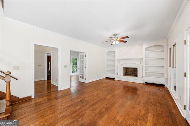 unfurnished living room with ceiling fan, baseboards, ornamental molding, wood finished floors, and built in features
