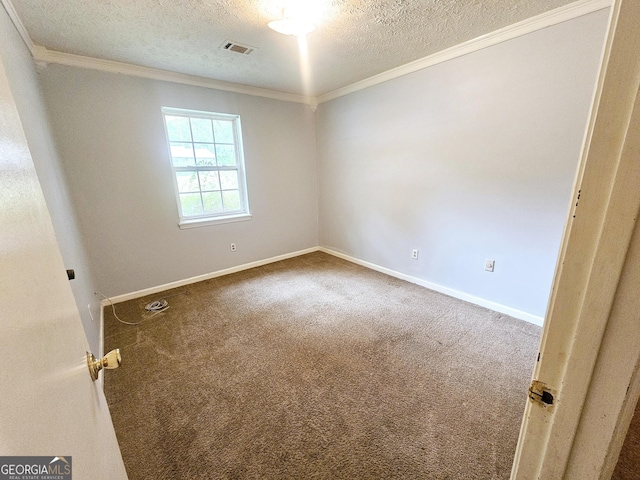 carpeted empty room with a textured ceiling, crown molding, and baseboards