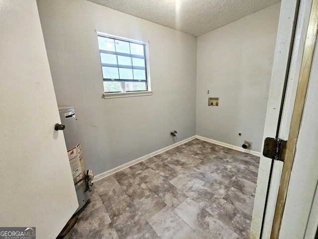clothes washing area with gas water heater, hookup for a washing machine, a textured ceiling, electric dryer hookup, and baseboards