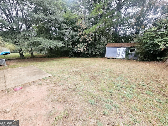 view of green lawn featuring a storage unit and an outdoor structure