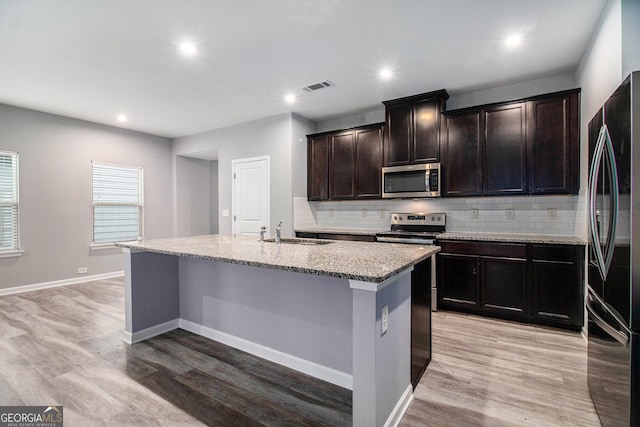 2769 Morgan Spring Trl, Buford, GA 30519 - kitchen featuring stainless steel appliances, a sink, light wood-type flooring, tasteful backsplash, and recessed lighting