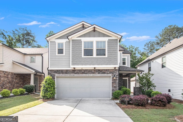 2769 Morgan Spring Trl, Buford, GA 30519 - craftsman house with stone siding, concrete driveway, a garage, board and batten siding, and a front yard