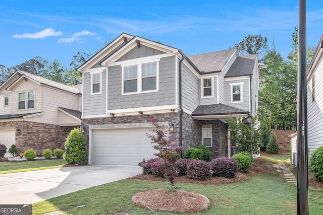 2769 Morgan Spring Trl, Buford, GA 30519 - view of front of property with stone siding, a garage, driveway, board and batten siding, and a front lawn