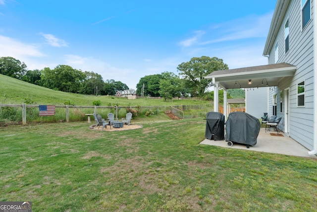 view of yard featuring a patio area and a fire pit