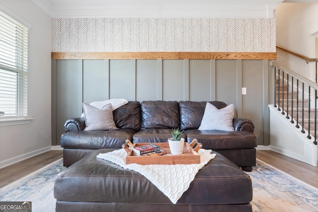 living room featuring crown molding, wood finished floors, stairway, and baseboards