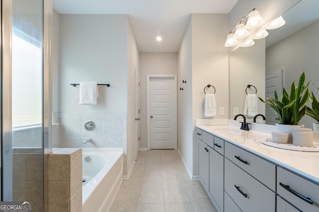 bathroom with vanity, tile patterned flooring, a garden tub, baseboards, and recessed lighting