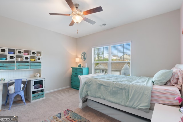 bedroom with light colored carpet, baseboards, and ceiling fan