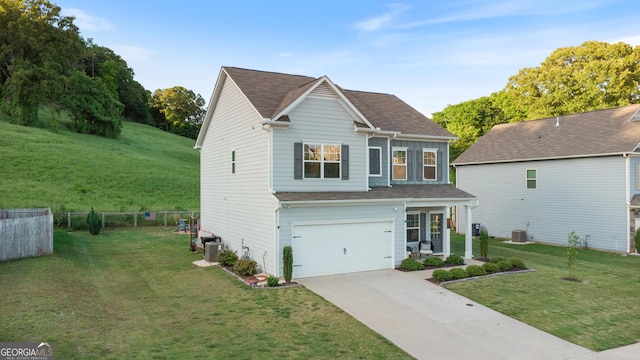 traditional home featuring concrete driveway, central air condition unit, an attached garage, and a shingled roof