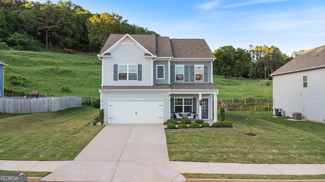 traditional home with concrete driveway, a garage, and central AC unit