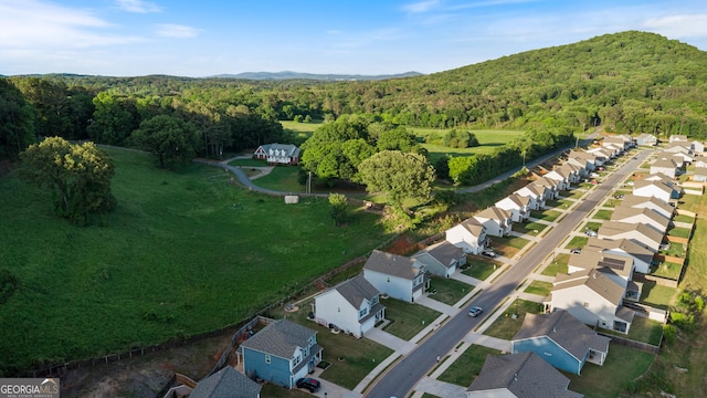 aerial overview of property's location with a forest and nearby suburban area