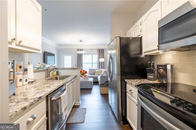 2700 Pine Tree Rd NE Unit 2204, Atlanta, GA 30324 - kitchen with stainless steel appliances, white cabinetry, dark wood-style floors, light stone counters, and ornamental molding
