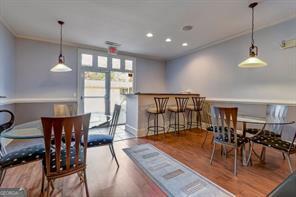 2700 Pine Tree Rd NE Unit 2204, Atlanta, GA 30324 - dining space featuring crown molding, wood finished floors, a dry bar, and recessed lighting