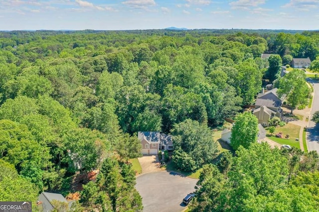 aerial overview of property's location featuring a heavily wooded area