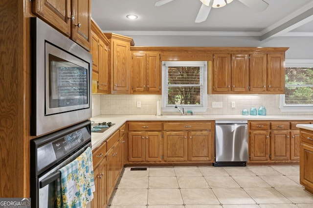 510 Jenna Trl, Mcdonough, GA 30252 - kitchen featuring appliances with stainless steel finishes, a sink, crown molding, light countertops, and a ceiling fan