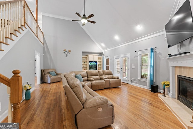 510 Jenna Trl, Mcdonough, GA 30252 - living area featuring high vaulted ceiling, stairway, baseboards, a high end fireplace, and wood finished floors