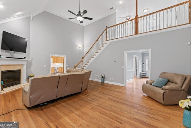 510 Jenna Trl, Mcdonough, GA 30252 - living area featuring ceiling fan, high vaulted ceiling, wood finished floors, a glass covered fireplace, and baseboards