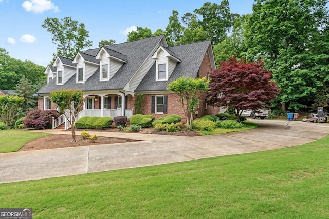 510 Jenna Trl, Mcdonough, GA 30252 - cape cod home featuring a porch, brick siding, concrete driveway, a front yard, and roof with shingles