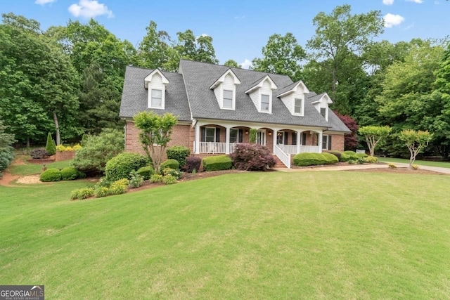 510 Jenna Trl, Mcdonough, GA 30252 - cape cod house with covered porch, brick siding, a front lawn, and roof with shingles