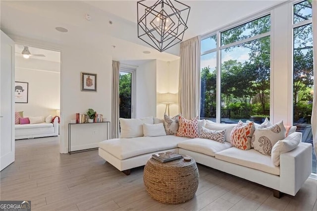1820 Peachtree St Unit 311, Atlanta, GA 30309 - living room featuring a chandelier and wood finished floors