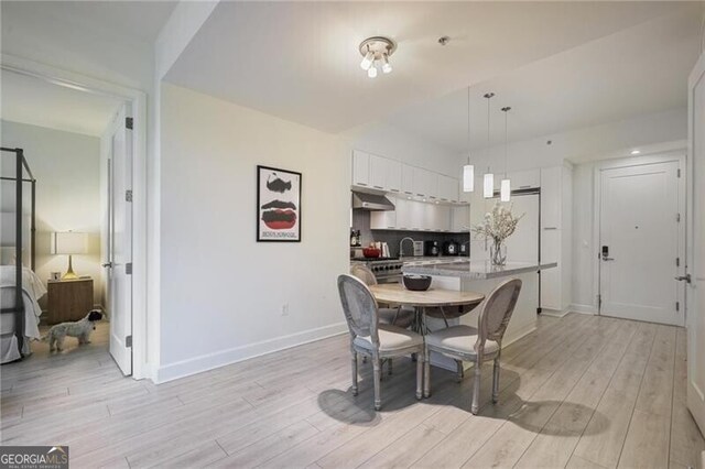 1820 Peachtree St Unit 311, Atlanta, GA 30309 - dining area with light wood-style floors and baseboards