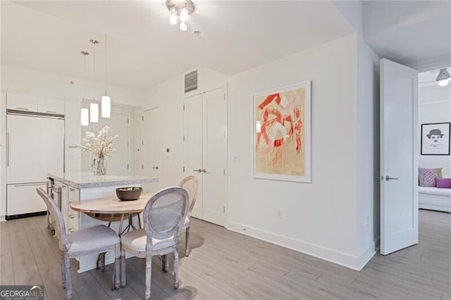1820 Peachtree St Unit 311, Atlanta, GA 30309 - dining area featuring light wood-style flooring and baseboards