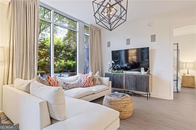 1820 Peachtree St Unit 311, Atlanta, GA 30309 - living room with a chandelier, wood finished floors, and baseboards