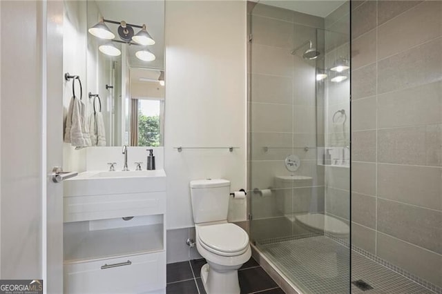 1820 Peachtree St Unit 311, Atlanta, GA 30309 - bathroom with a stall shower, toilet, tile patterned floors, and vanity