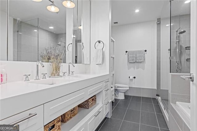 1820 Peachtree St Unit 311, Atlanta, GA 30309 - bathroom with tile patterned floors, a shower stall, toilet, vanity, and recessed lighting
