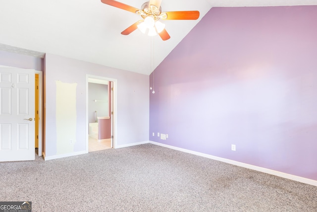 unfurnished bedroom with carpet flooring, baseboards, high vaulted ceiling, ensuite bathroom, and ceiling fan