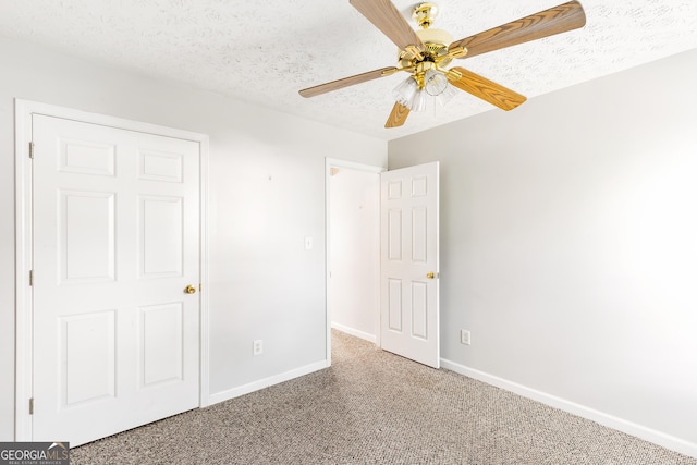 unfurnished bedroom featuring carpet flooring, baseboards, ceiling fan, and a textured ceiling