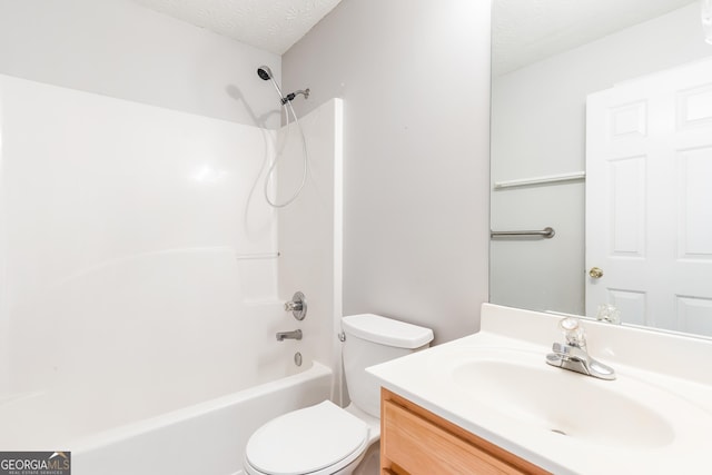 bathroom with toilet, vanity, a textured ceiling, and shower / bath combination