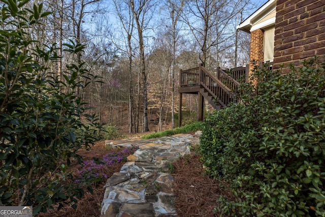 view of yard featuring stairs and a deck
