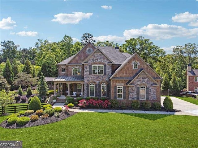 colonial home with a porch and stone siding
