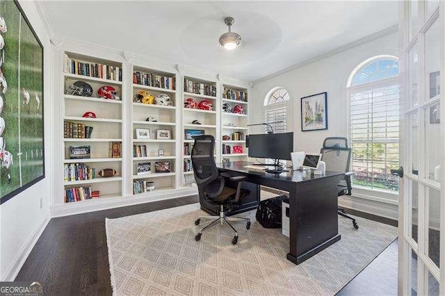 office area with ornamental molding, wood finished floors, built in features, and baseboards