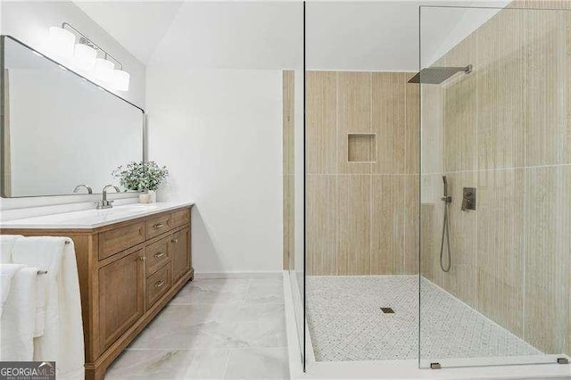 bathroom featuring a walk in shower, vanity, and marble finish flooring