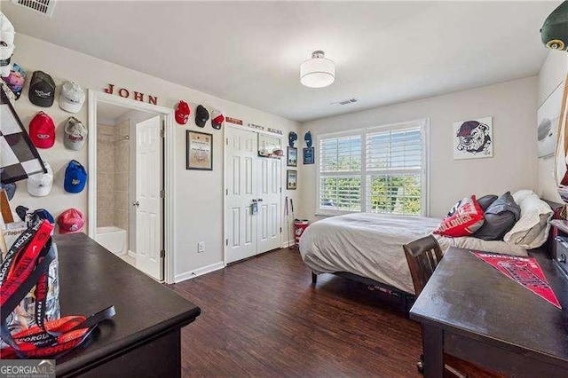 bedroom featuring dark wood-style floors and baseboards
