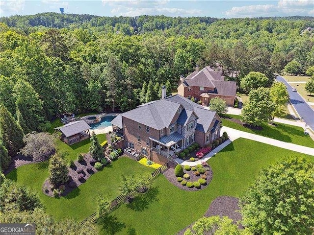view of subject property with a forest