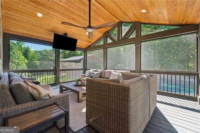 sunroom / solarium featuring outdoor lounge area, ceiling fan, vaulted ceiling, and healthy amount of natural light
