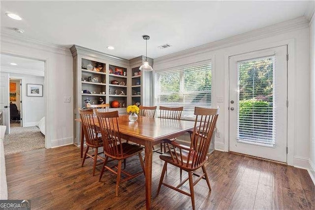 dining space with crown molding, healthy amount of natural light, wood finished floors, baseboards, and recessed lighting
