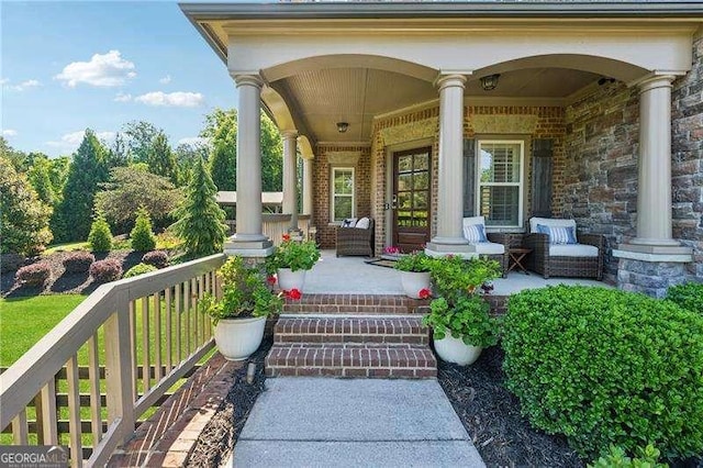 entrance to property featuring covered porch and brick siding